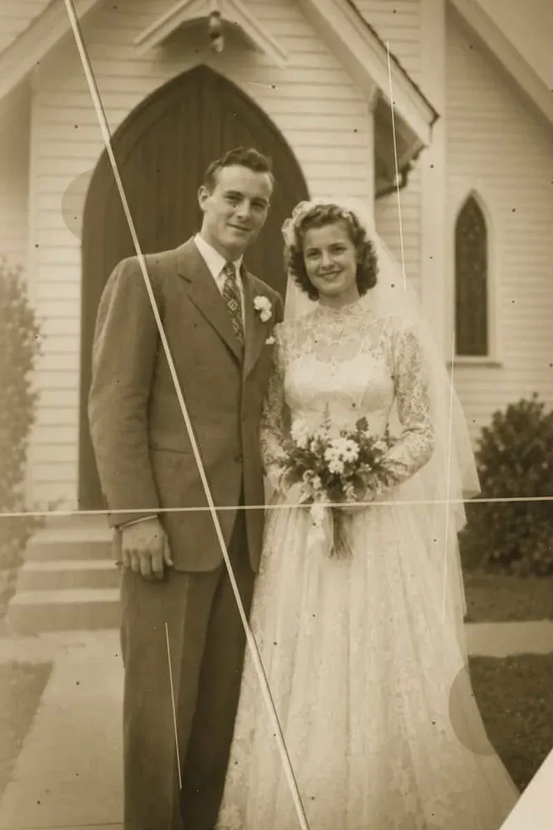 1940s wedding photograph outside a church — damaged original